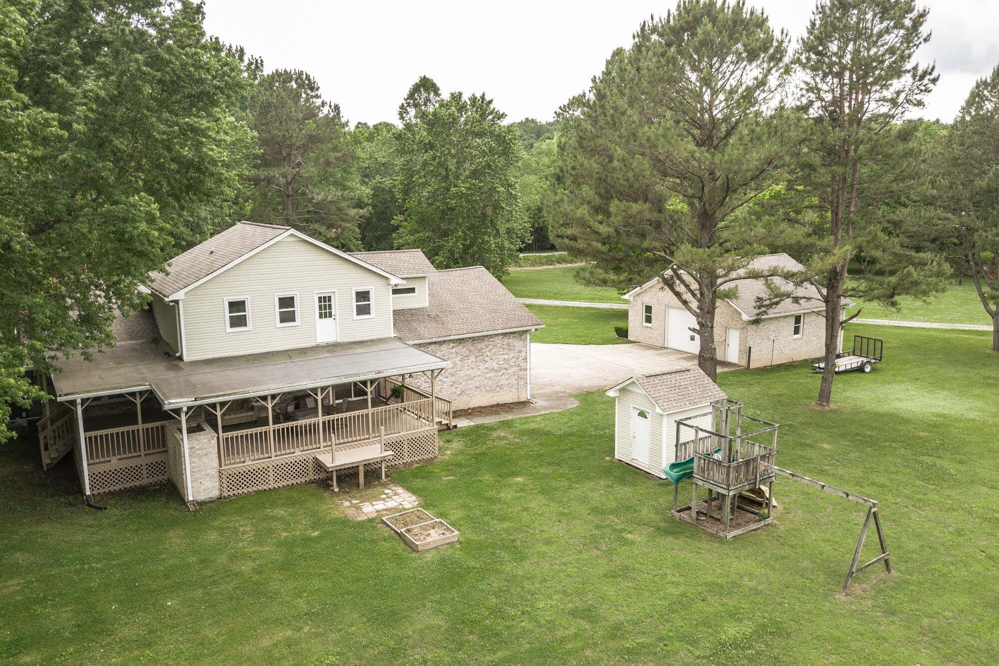 8114 Ridgewood Road Goodlettsville, TN 37072 - Photo 26 of 30 An aerial view of the home with the detached garage, play set and storage building.