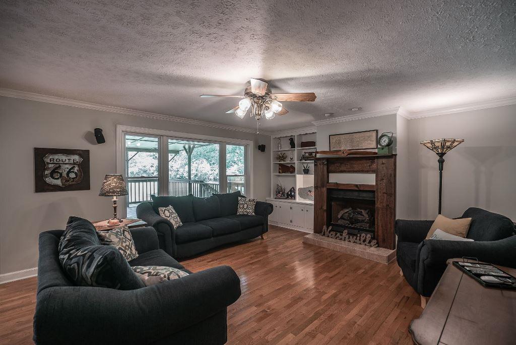 8114 Ridgewood Road Goodlettsville, TN 37072 - Photo 5 of 30 Living room with beautiful hardwood floors, gas log fireplace & built-in shelf.