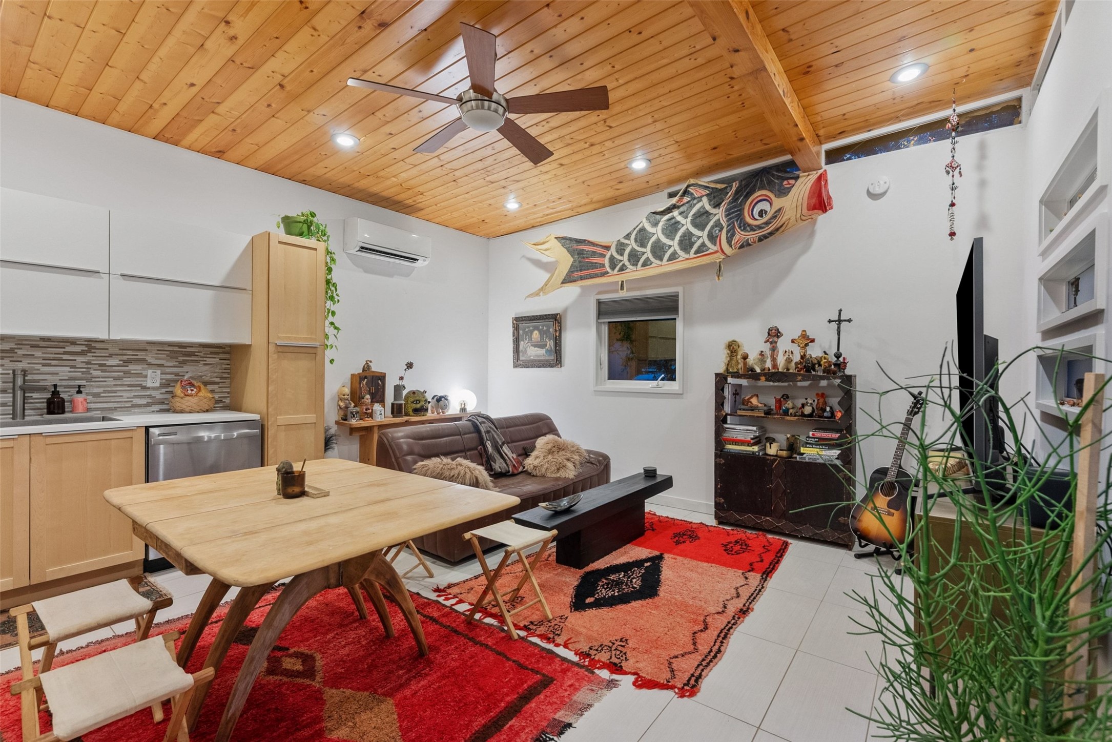 412 West Croslin Street Austin, TX 78752 - Photo 24 of 36 Natural wood ceilings and a ceiling fan enhance this combined living and kitchen space.