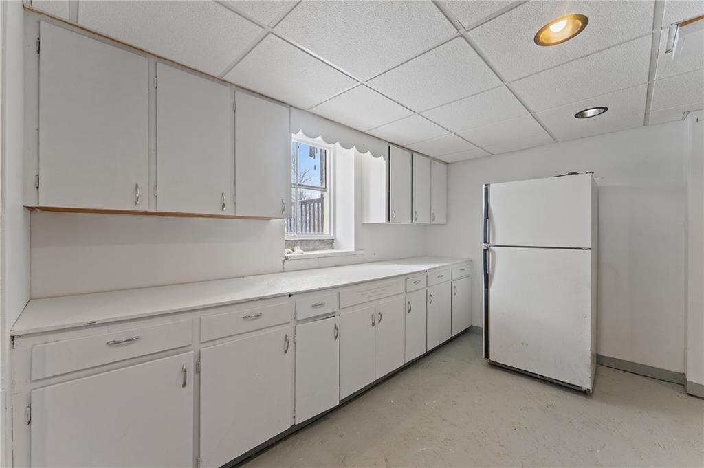 4321 Edinburg Road New Castle, PA 16102 - Photo 26 of 43 a kitchen with cabinets and a refrigerator