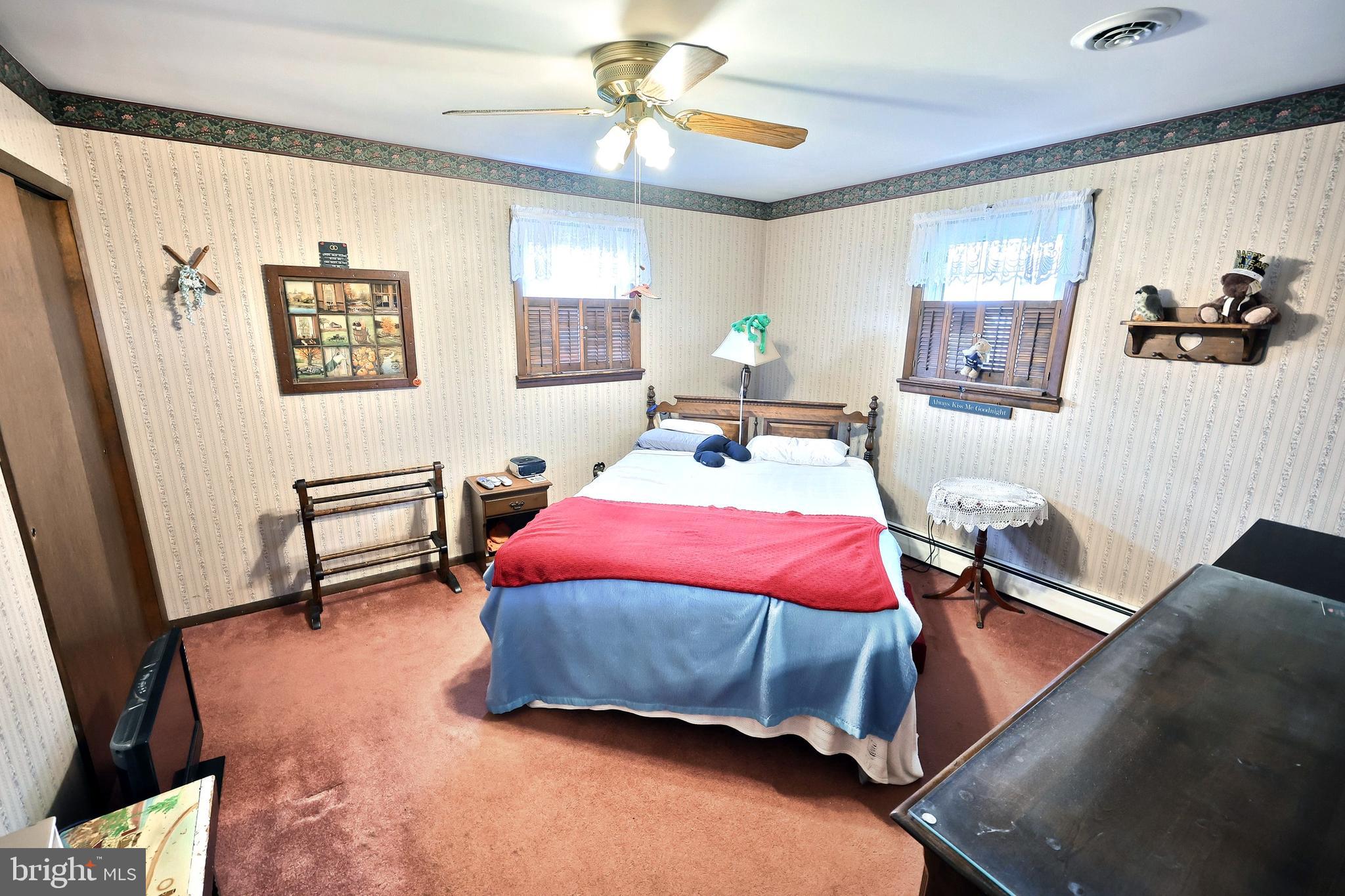 4999 Lehman Road Spring Grove, PA 17362 - Photo 20 of 32 a bedroom with a bed a dresser and a window