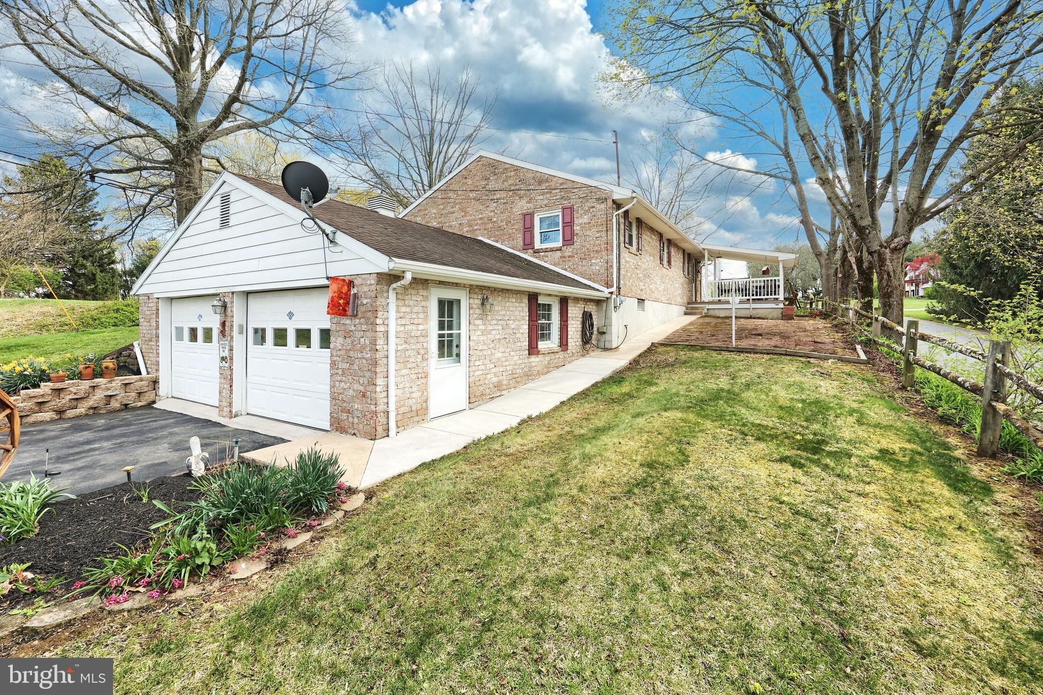 4999 Lehman Road Spring Grove, PA 17362 - Photo 5 of 32 a view of a white house next to a yard with big trees