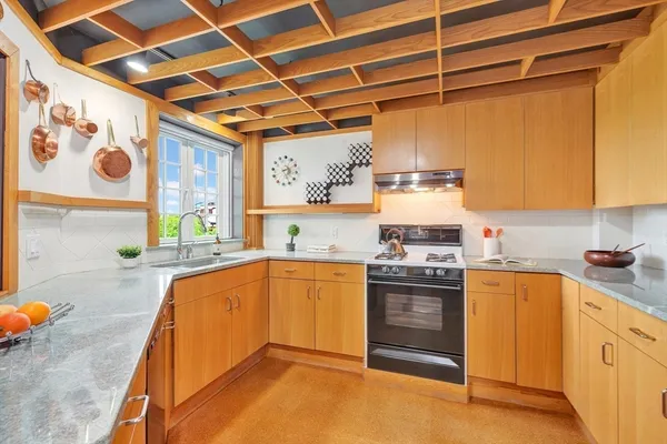 a kitchen with stainless steel appliances granite countertop a stove and a sink