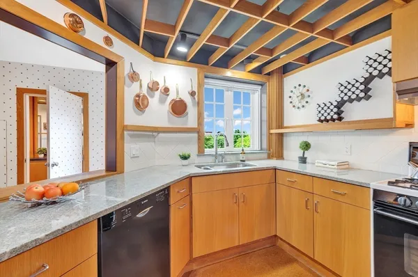 a kitchen with a sink window and cabinets
