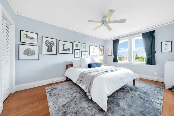 a bedroom with a large bed and a window