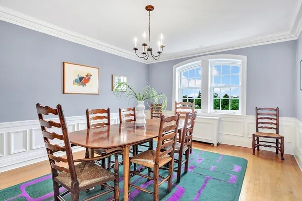 a view of a dining room with furniture and a chandelier