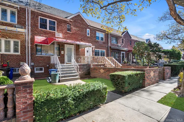 a front view of a house with a garden