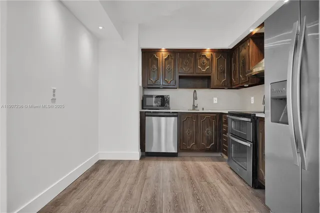 a kitchen with stainless steel appliances granite countertop a stove and a microwave