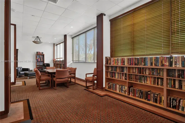 a living room with furniture gym equipment and a large window
