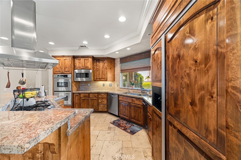 38136 Butterfly Court Yucaipa, CA 92399 - Photo 36 of 71 a kitchen with stainless steel appliances granite countertop a sink stove and refrigerator
