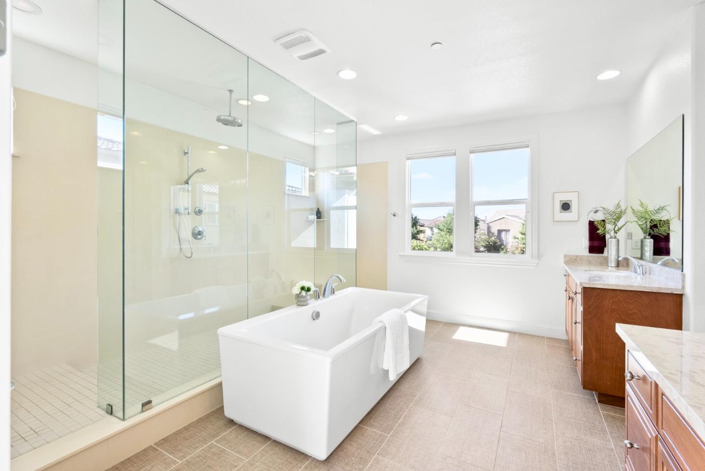 532 Hyacinthus Court San Ramon, CA 94582 - Photo 22 of 31 a bathroom with a tub a sink a mirror and a shower
