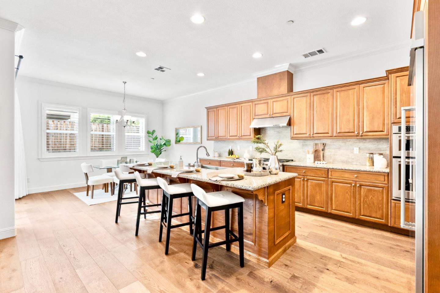 532 Hyacinthus Court San Ramon, CA 94582 - Photo 6 of 31 a kitchen with cabinets a dining table and chairs