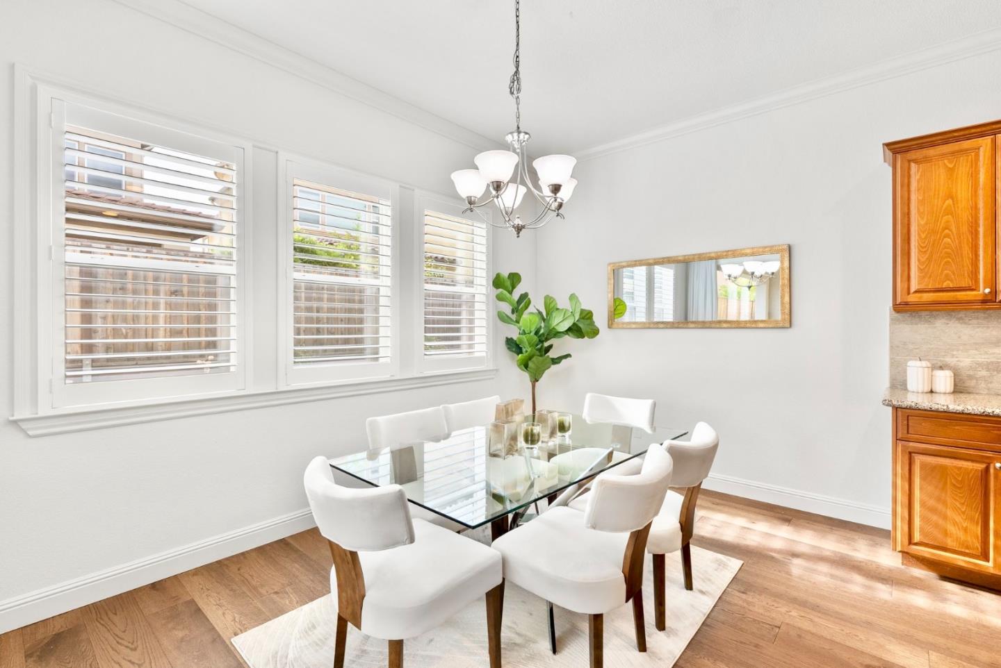 532 Hyacinthus Court San Ramon, CA 94582 - Photo 9 of 31 a dining room with furniture a potted plant and a chandelier
