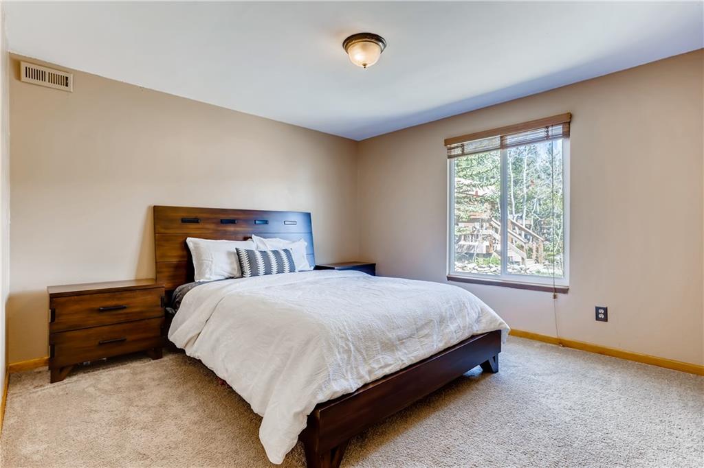 115 Reiling Road Breckenridge, CO 80424 - Photo 12 of 35 a large bed sitting in a bedroom next to a window