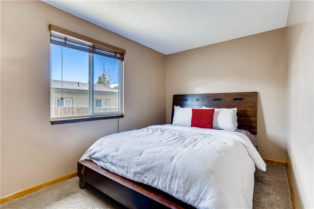 115 Reiling Road Breckenridge, CO 80424 - Photo 14 of 35 a bedroom with a bed and window
