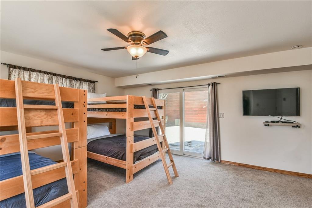 115 Reiling Road Breckenridge, CO 80424 - Photo 16 of 35 a bedroom with a bed and a flat screen tv
