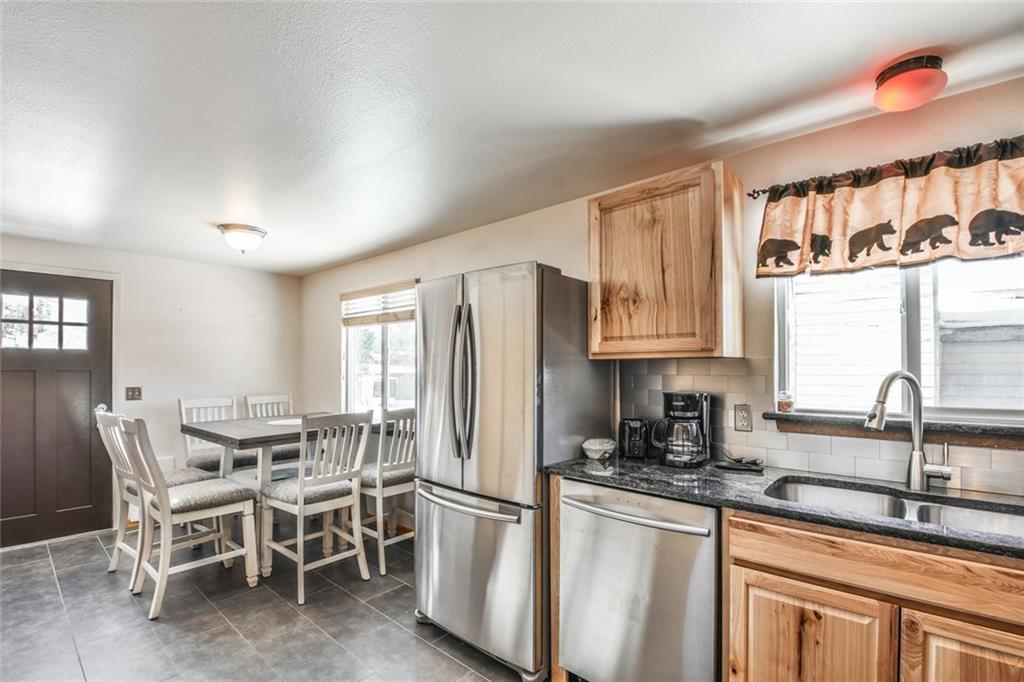 115 Reiling Road Breckenridge, CO 80424 - Photo 4 of 35 a kitchen with stainless steel appliances granite countertop a sink stove and refrigerator