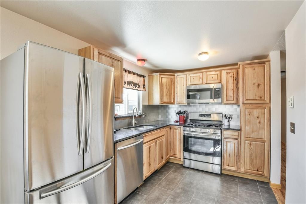 115 Reiling Road Breckenridge, CO 80424 - Photo 5 of 35 a kitchen with stainless steel appliances a refrigerator stove and sink
