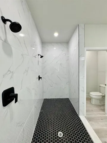 a bathroom with a toilet and a shower
