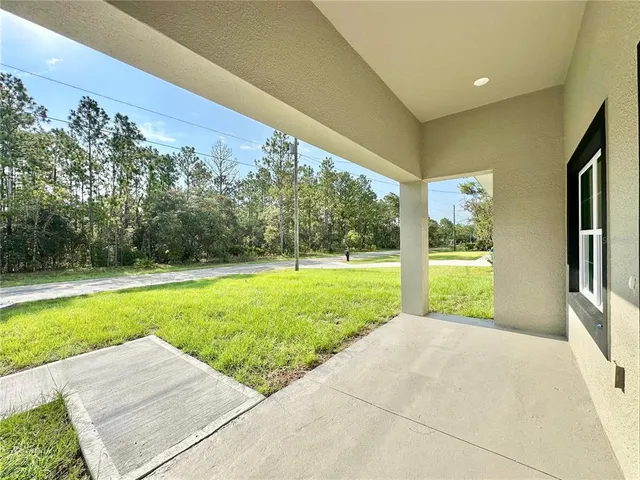 a view of a house with backyard and porch