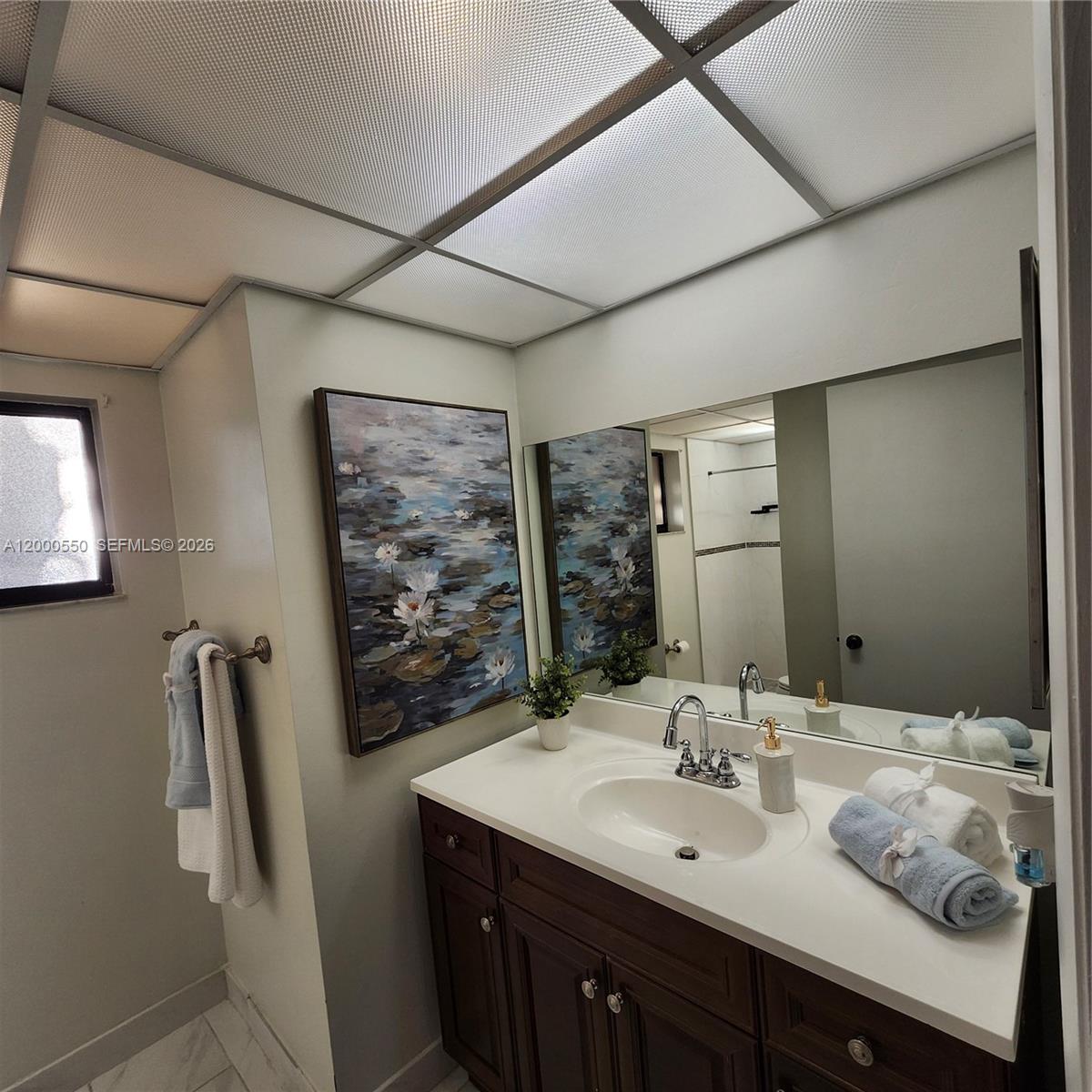 8415 Southwest 107th Avenue, Unit 238W Miami, FL 33173 - Photo 1 of 30 a bathroom with a sink mirror and a shower