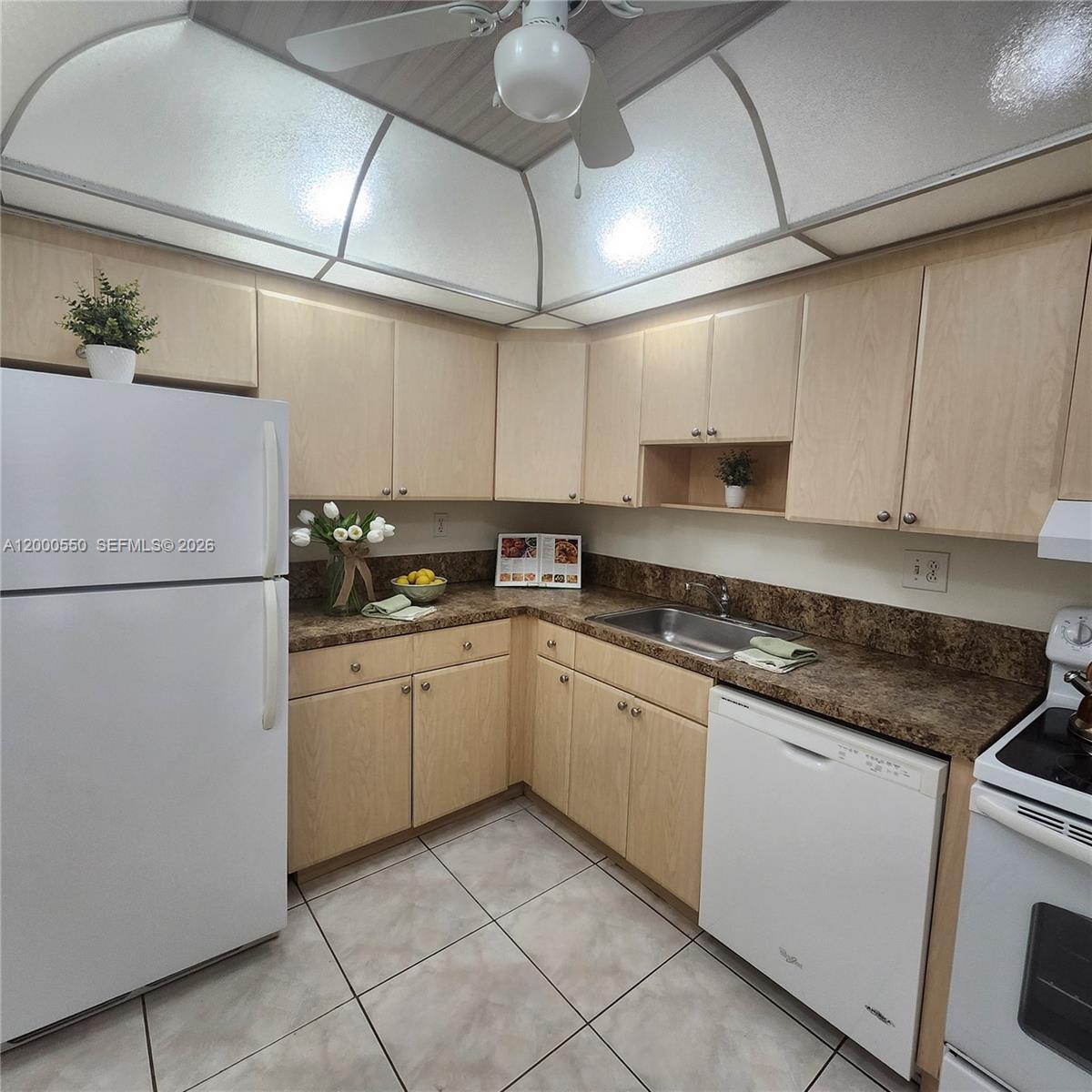 8415 Southwest 107th Avenue, Unit 238W Miami, FL 33173 - Photo 15 of 30 a kitchen with cabinets appliances a sink and a counter top space