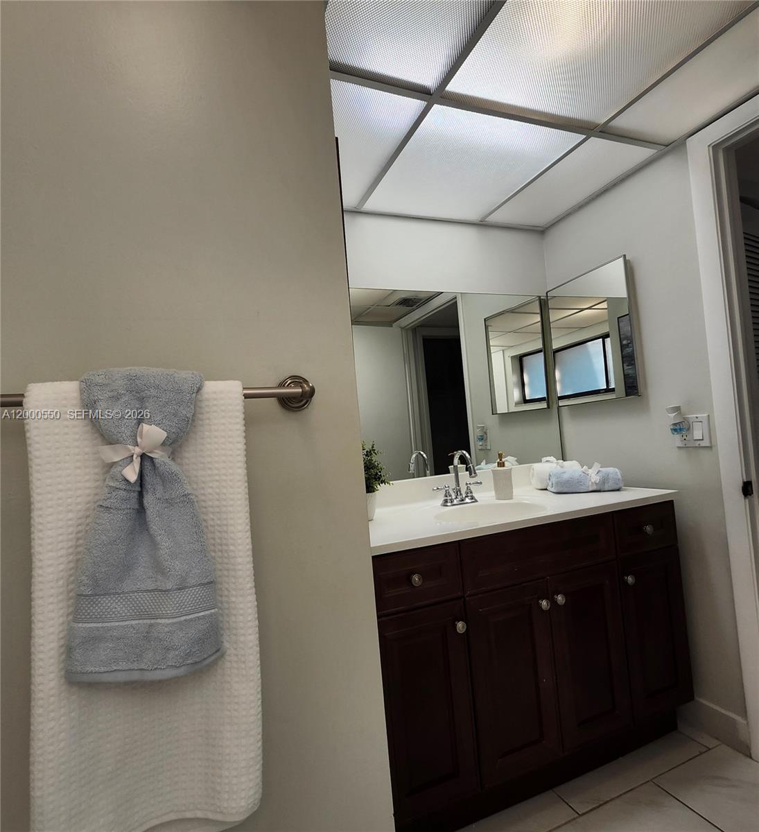 8415 Southwest 107th Avenue, Unit 238W Miami, FL 33173 - Photo 2 of 30 a bathroom with a sink and mirror