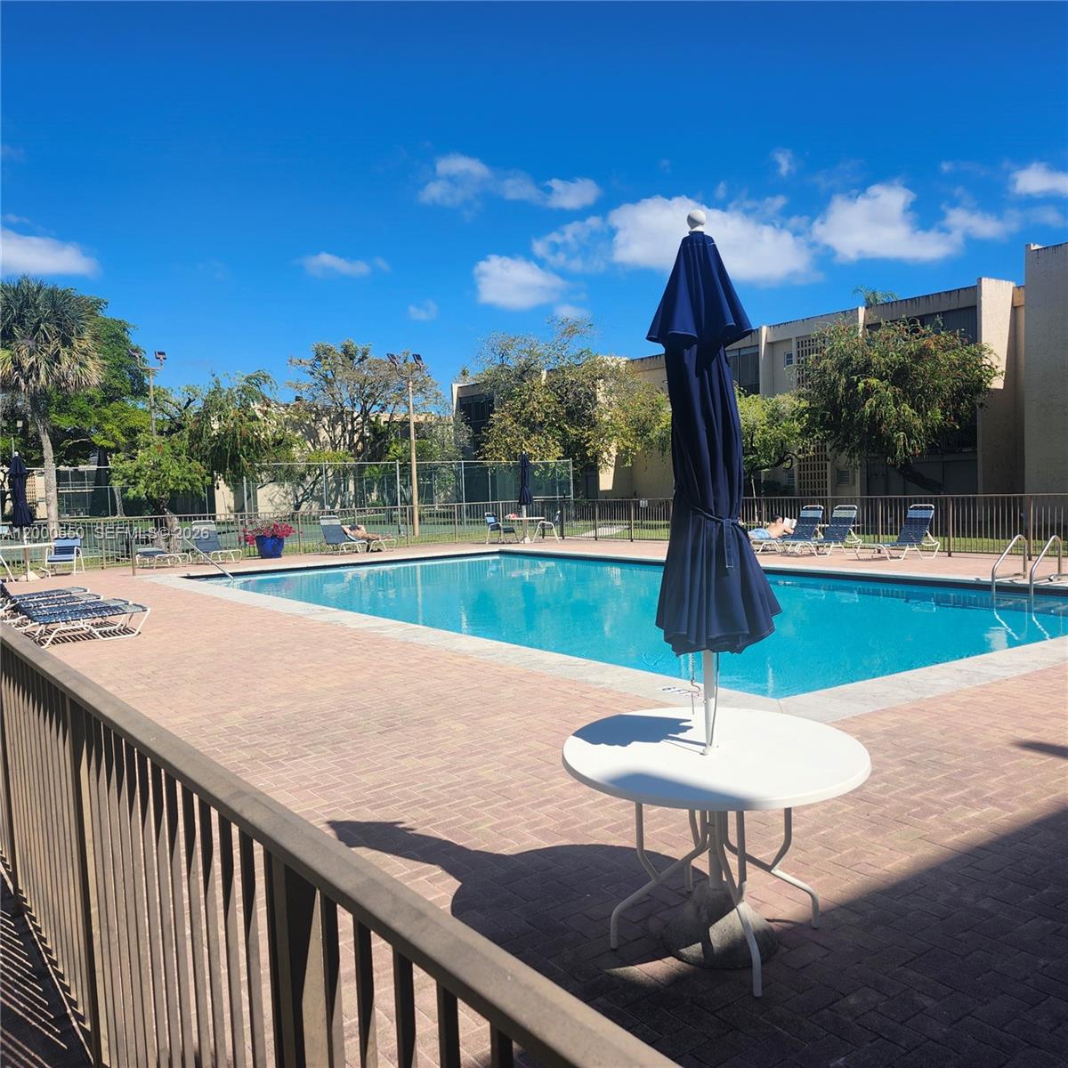 8415 Southwest 107th Avenue, Unit 238W Miami, FL 33173 - Photo 24 of 30 a swimming pool with a yard and outdoor seating
