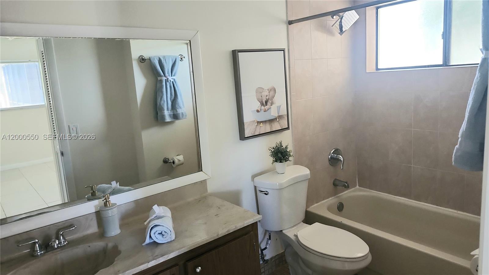8415 Southwest 107th Avenue, Unit 238W Miami, FL 33173 - Photo 6 of 30 a bathroom with a sink a toilet and shower