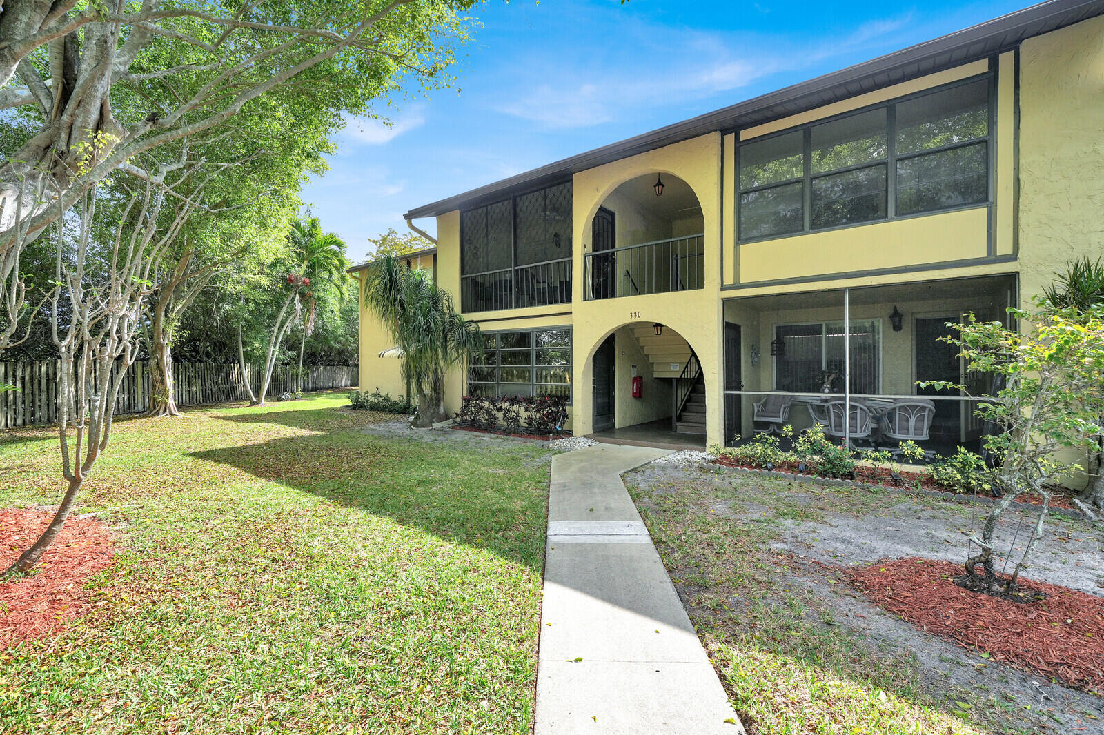 330 Pine Ridge Circle, Unit B2 Greenacres, FL 33463 - Photo 1 of 22 a front view of a house with garden