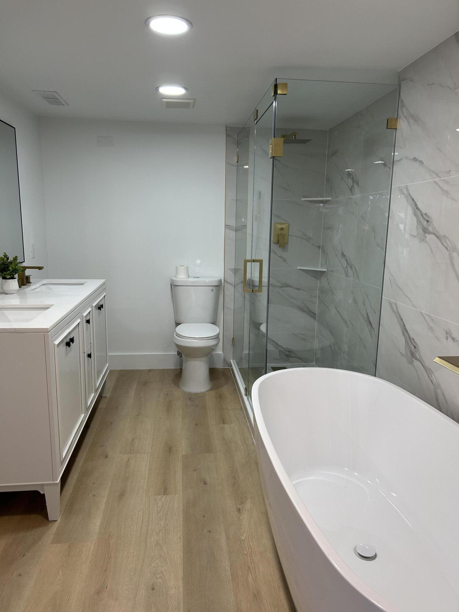 330 Pine Ridge Circle, Unit B2 Greenacres, FL 33463 - Photo 20 of 22 a bathroom with a bathtub and a toilet