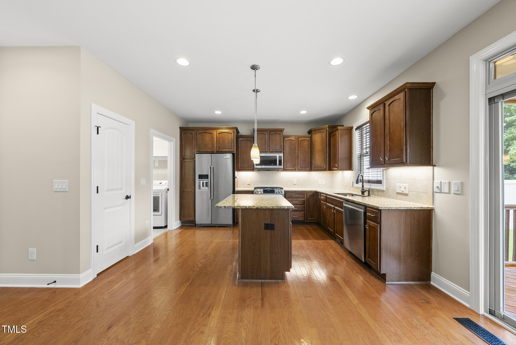 5120 Audreystone Drive Cary, NC 27518 - Photo 28 of 65 a large kitchen with stainless steel appliances granite countertop a stove a sink dishwasher and a refrigerator with wooden floor