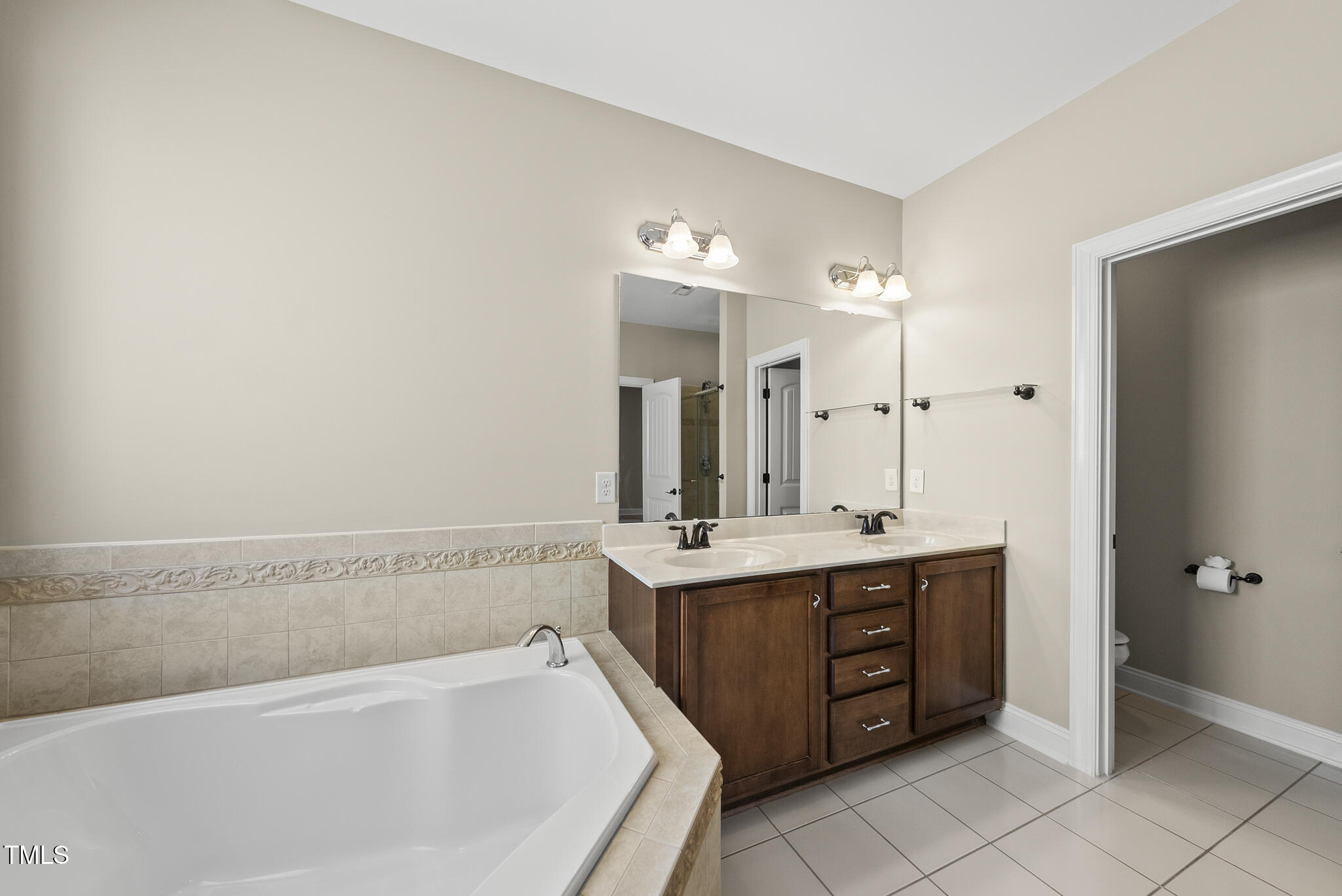 5120 Audreystone Drive Cary, NC 27518 - Photo 37 of 65 a spacious bathroom with a bathtub sink and mirror