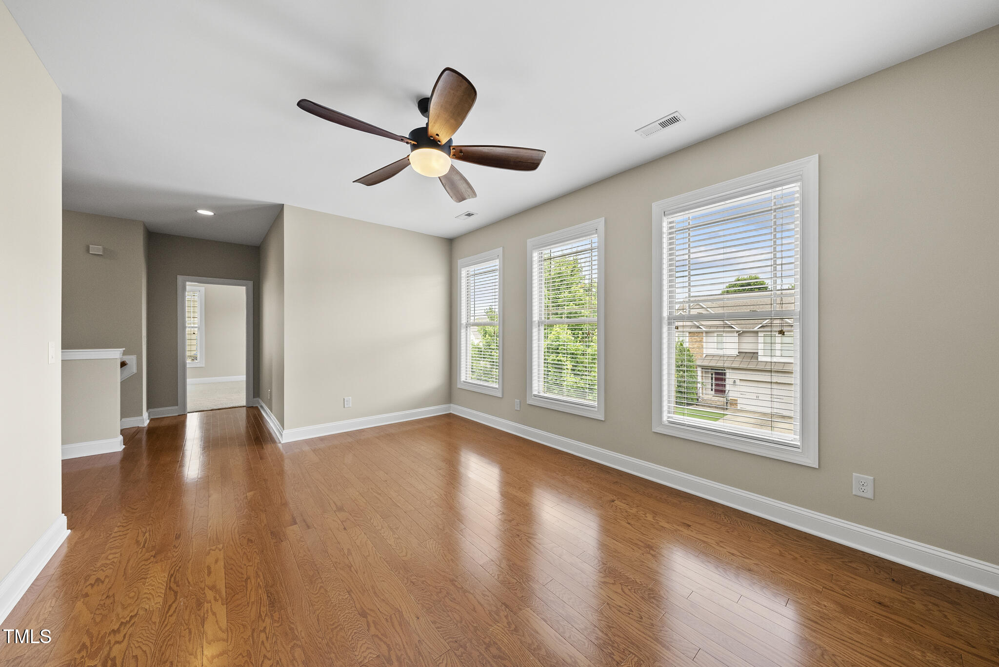 5120 Audreystone Drive Cary, NC 27518 - Photo 40 of 65 a view of an empty room with wooden floor and a window
