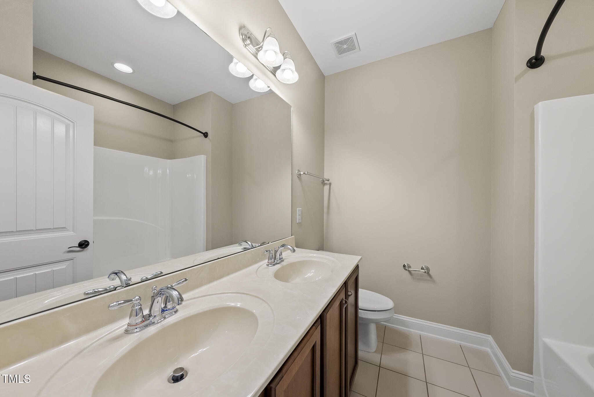 5120 Audreystone Drive Cary, NC 27518 - Photo 45 of 65 a bathroom with a sink a toilet and shower