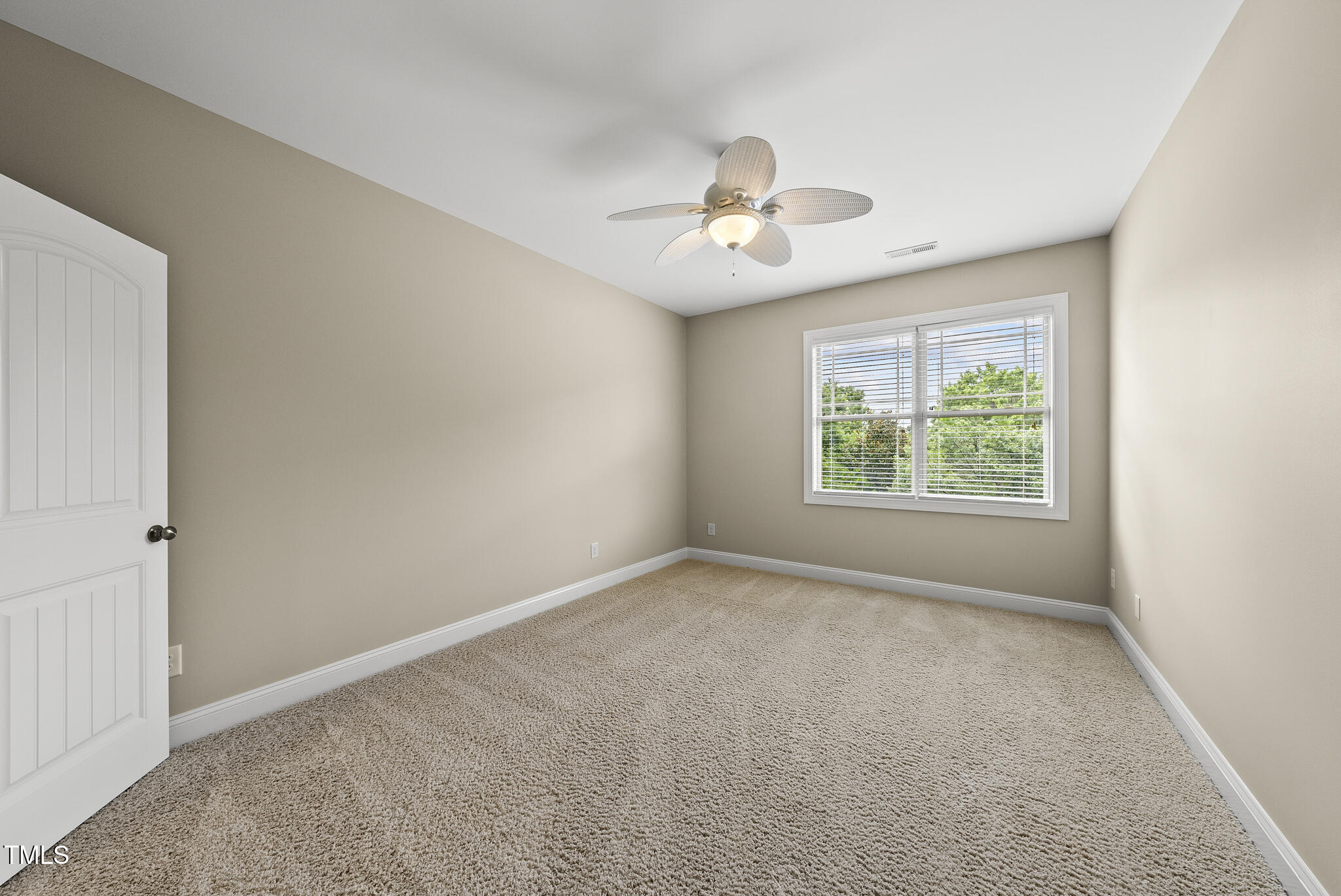 5120 Audreystone Drive Cary, NC 27518 - Photo 46 of 65 an empty room with a window and a ceiling fan