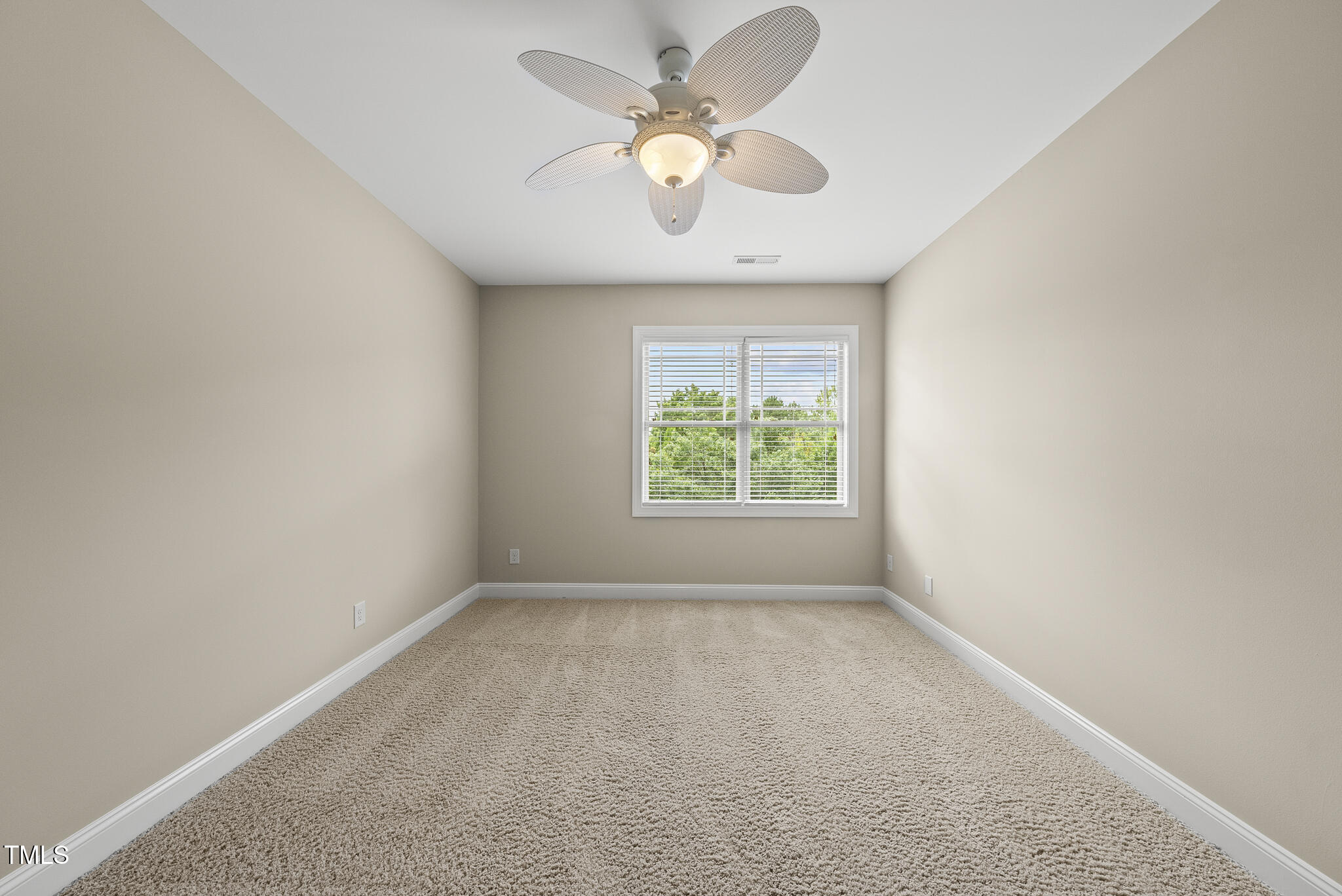 5120 Audreystone Drive Cary, NC 27518 - Photo 47 of 65 an empty room with a window and a fan