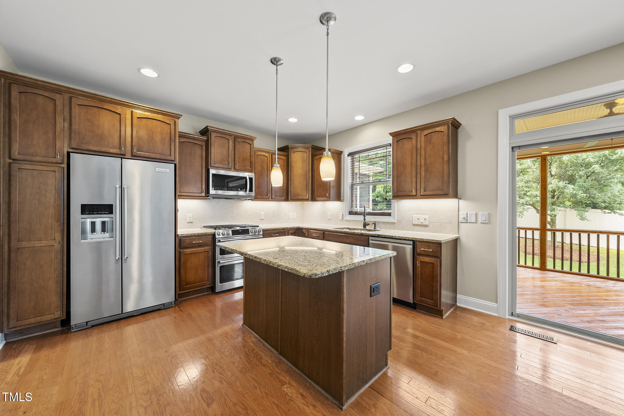 5120 Audreystone Drive Cary, NC 27518 - Photo 4 of 65 a kitchen with stainless steel appliances granite countertop a refrigerator a stove a sink and a chandelier