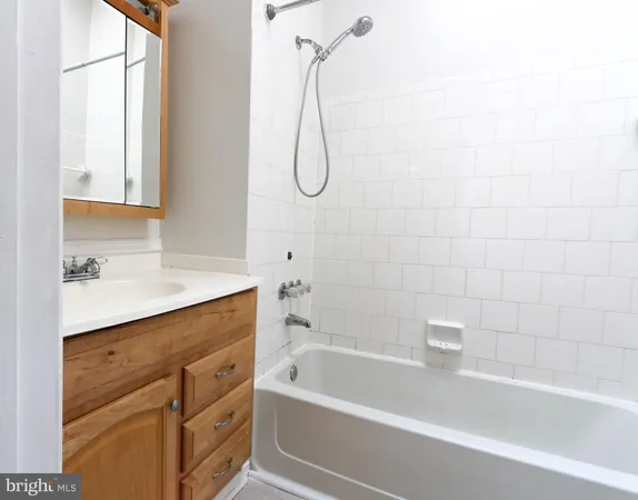 a bathroom with a bath tub with a shower