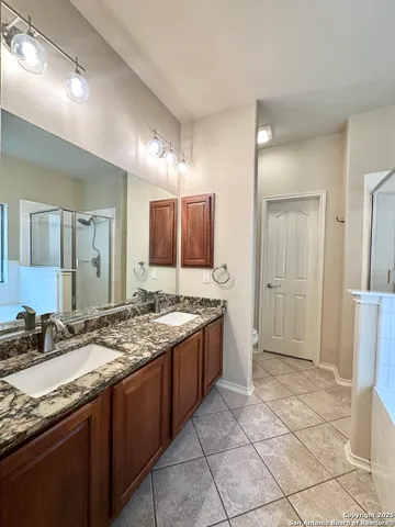 a large bathroom with a granite countertop sink and a mirror