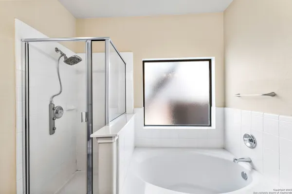 a bathroom with a bathtub and a shower