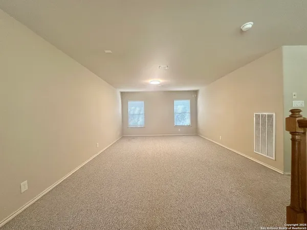 a view of empty room with windows