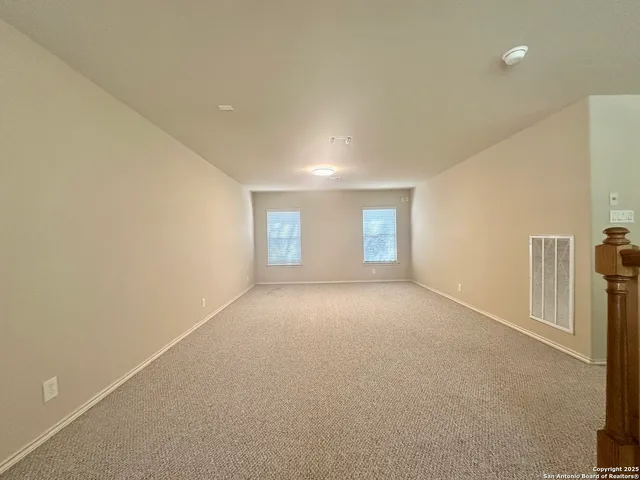 a view of empty room with windows