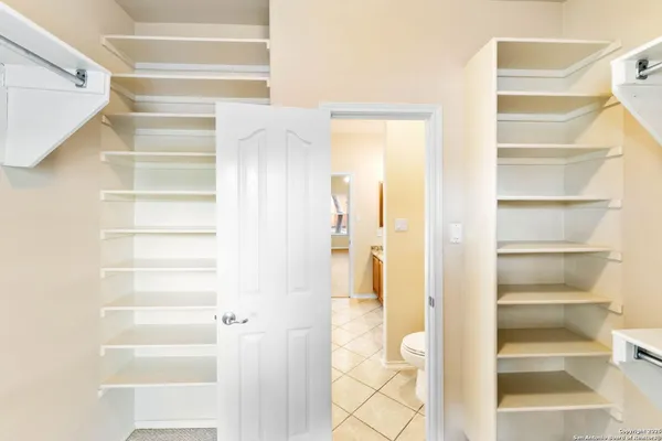 a view of a walk in closet with empty racks