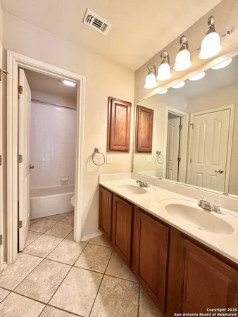 a spacious bathroom with a bathtub sink mirror and a shower