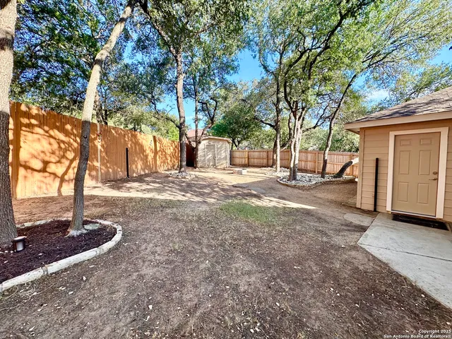a view of a yard with a tree