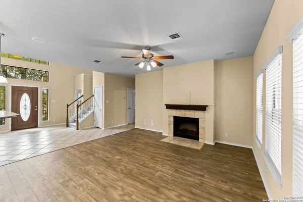 a view of an empty room with a fireplace and a window