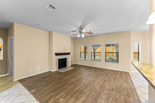 wooden floor chandelier and windows in a room