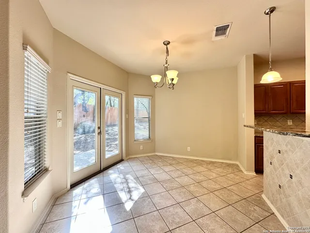 a view of a kitchen with furniture and chandelier