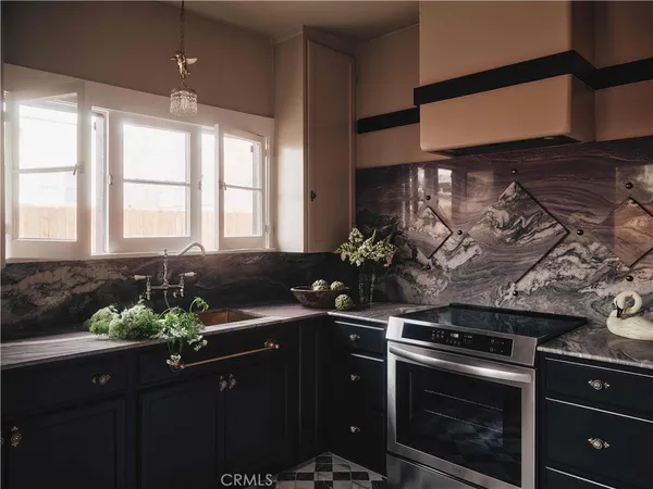 a kitchen with a sink stove and cabinets